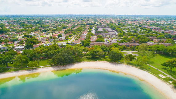 Panoramic view of a residential area with a body of water in the foreground.