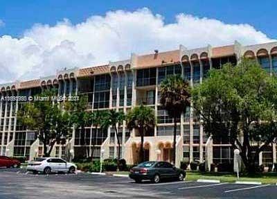 Front view of a multi-story apartment building with multiple balconies.