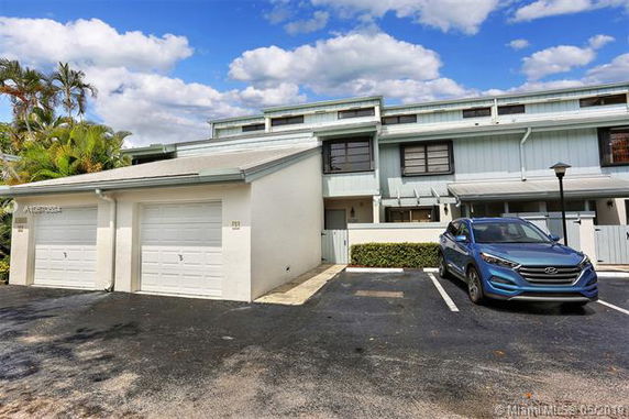 Front view of a multi-story residential building with attached garages.
