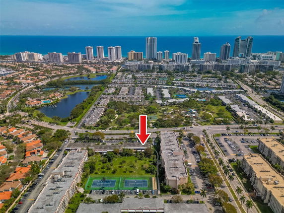 Aerial view of a residential and urban area with tall buildings near the coastline.