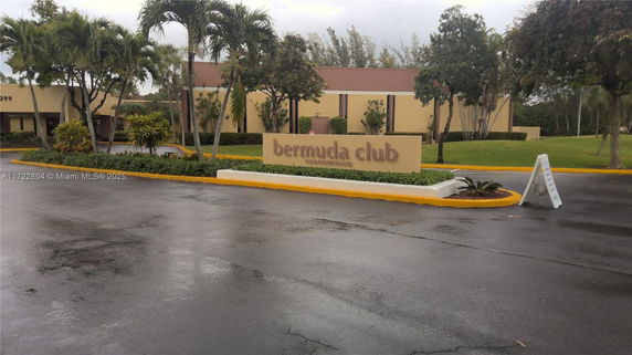 Front view of a building labeled 'Bermuda Club' with a landscaped entrance.