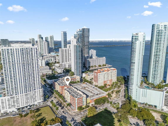 Aerial view of a cityscape with a mix of high-rise buildings and water bodies.
