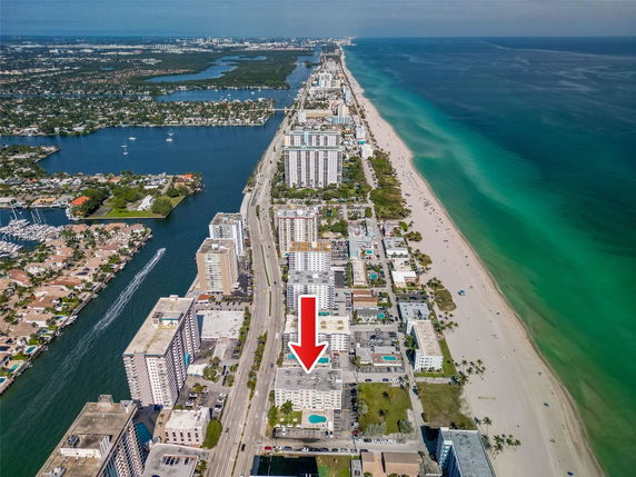 Aerial view of a coastal area with high-rise buildings adjacent to the beach.
