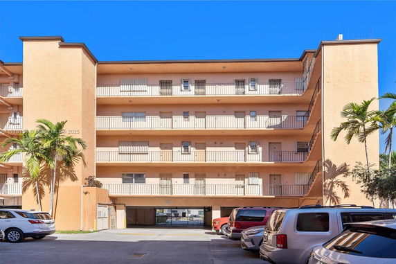 Front view of a multi-story residential building with balconies.