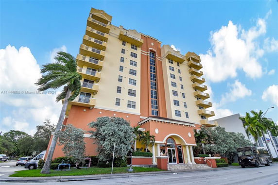 Front view of a multi-story building with balconies and a main entrance.