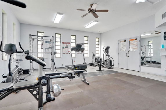 Indoor gym area with exercise equipment and mirrors.