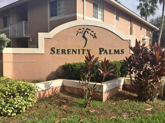 Front view of a two-story building with signage for Serenity Palms.