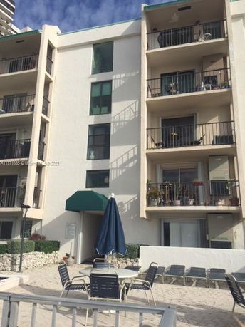 Front view of a multi-story residential building with balconies.