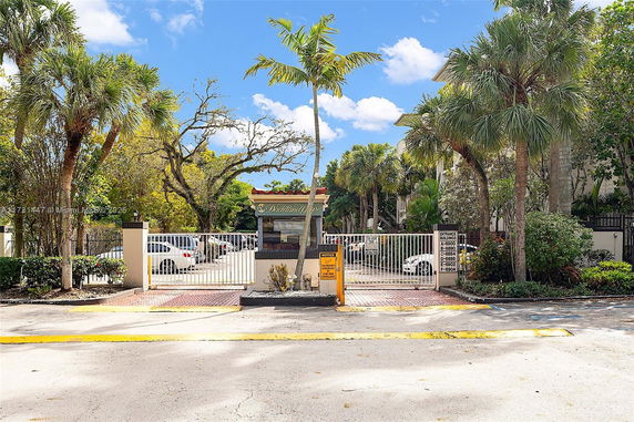 Parking area with gated entrance and guard booth.