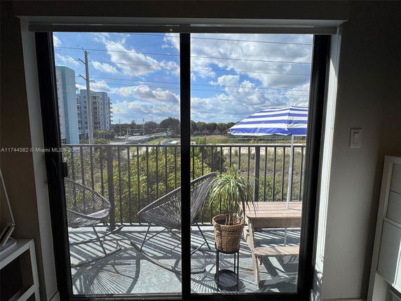 View from a balcony showing surrounding buildings and landscape.