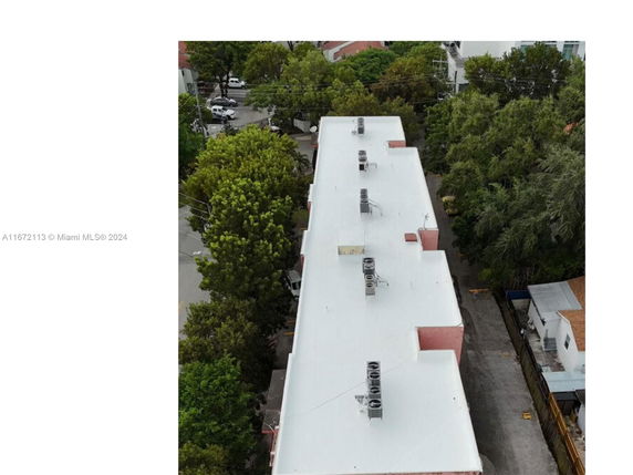Rooftop view of a building with multiple air conditioning units installed.