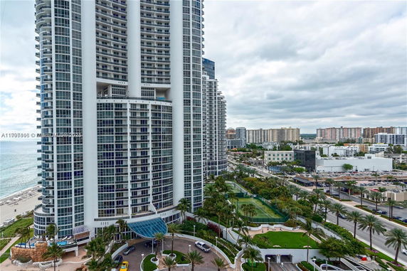 High-rise building near the beach with surrounding cityscape view.