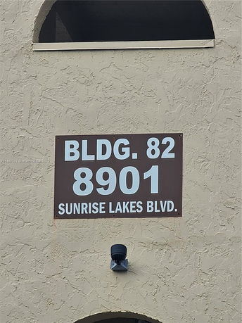 Exterior view of a building with a sign displaying 'Bldg. 82, 8901 Sunrise Lakes Blvd.'