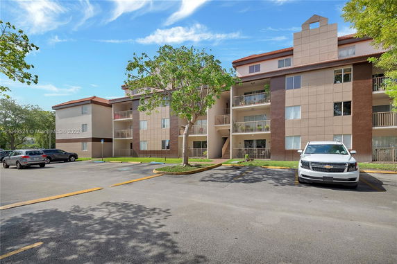 Front view of a multi-story residential building with balconies.