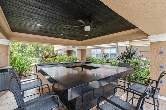 Outdoor sitting area with a covered patio and barbecue setup.