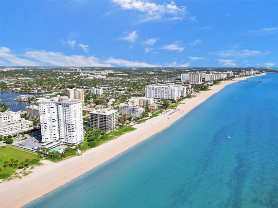 Panoramic view of beachfront buildings and coastline.