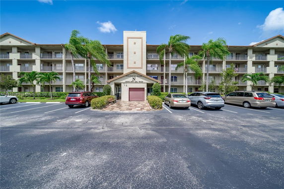 Front view of a multi-story residential building with balconies.