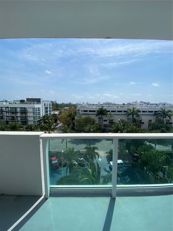 View from a balcony overlooking streets and distant buildings.