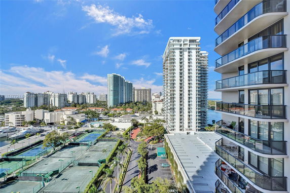 View of high-rise buildings and tennis courts from an elevated position.