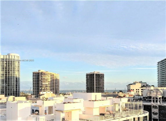 Panoramic view of high-rise buildings with ocean in the background.