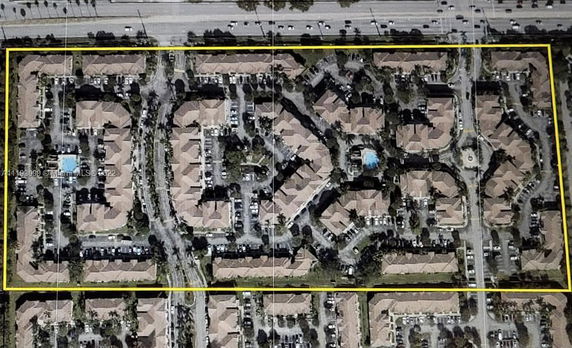 Aerial view of a residential complex with multiple buildings and roads.