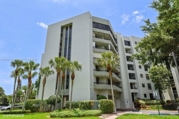 Front view of a multi-story residential building with balconies.