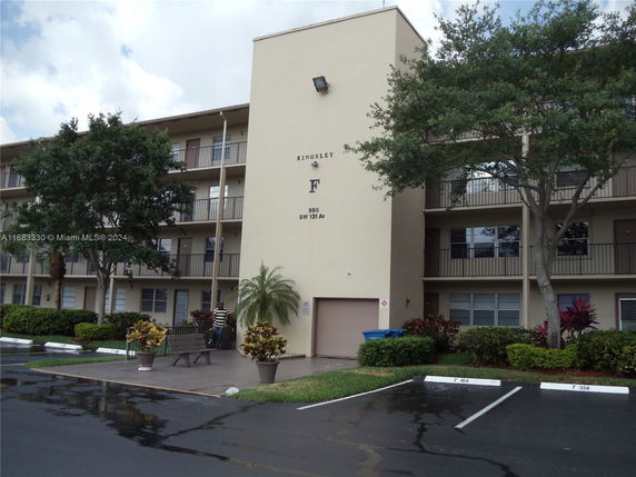 Front view of a multi-story residential building with balconies.
