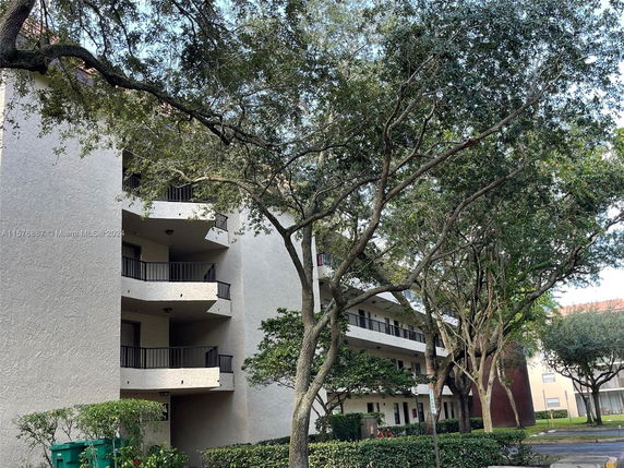 Front view of a multi-story building with balconies.