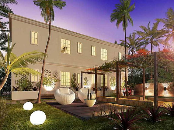 Front view of a two-story house with outdoor seating area and landscaping.