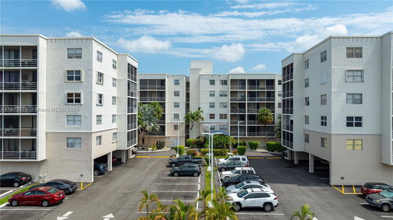 Outdoor parking area in front of multi-story residential buildings.