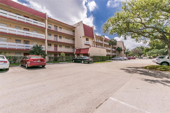 Front view of a multi-story residential building with balconies.