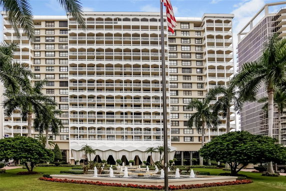 Front view of a multi-story residential building with balconies.