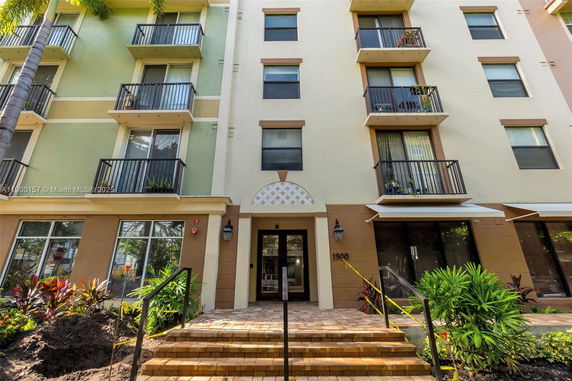 Front view of a multi-story building with balconies.
