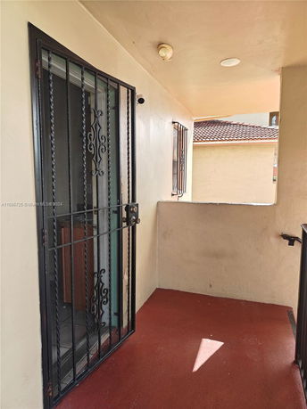 Front area with a metal security door and barred windows.