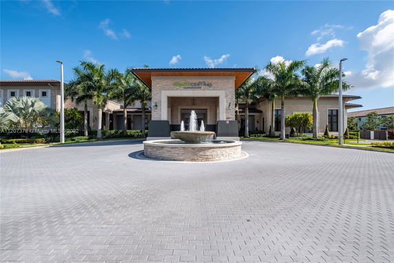 Front view of a building with a fountain at the entrance.