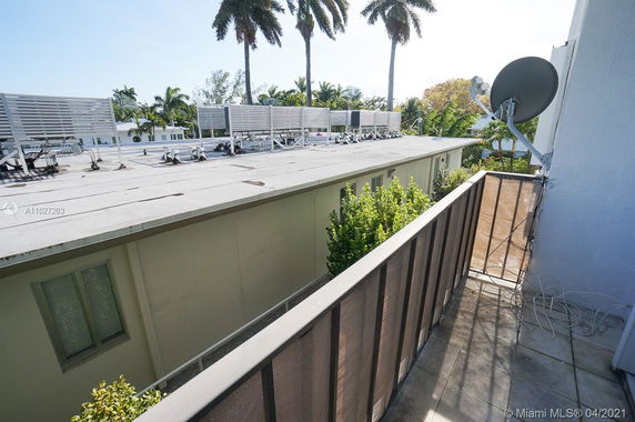 Rooftop with multiple air conditioning units and a satellite dish.