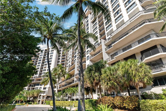 Front view of a multi-story residential building with balconies.
