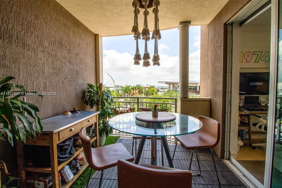 View from a balcony showing outdoor seating and surrounding area.