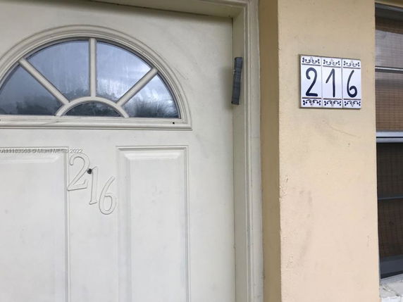 Front view of a house door with the number 216.
