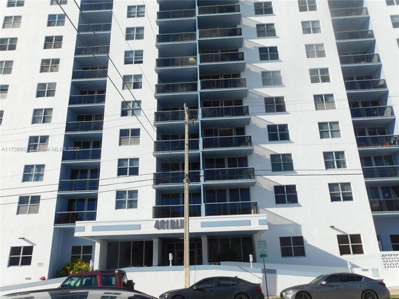 Front view of a multi-story residential building with balconies.