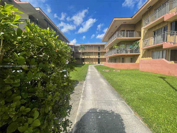 Front view of a multi-story residential building with balconies.