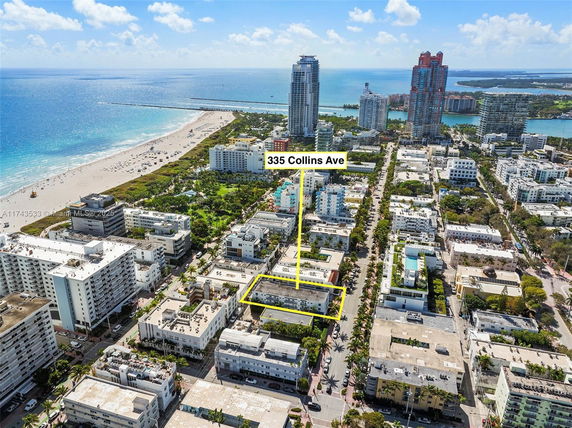 Aerial view of a coastal urban area with a beach, buildings, and highlighted location on Collins Ave.