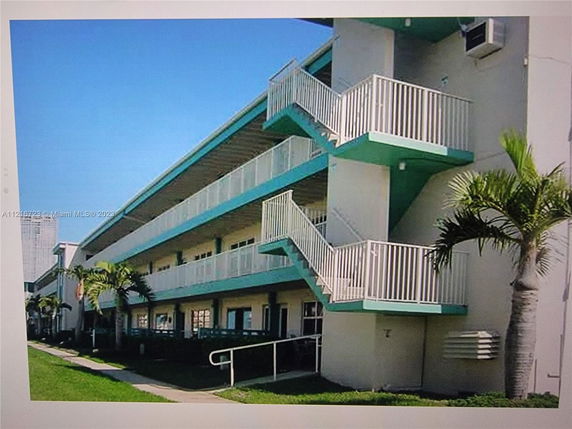 Front view of a multi-story residential building with external staircases.