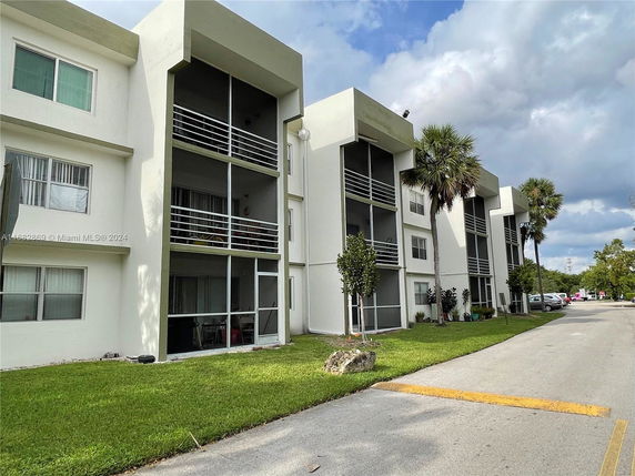 Front view of a multi-story residential building with balconies.