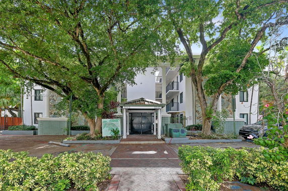 Front view of a multi-story building with gated entrance.