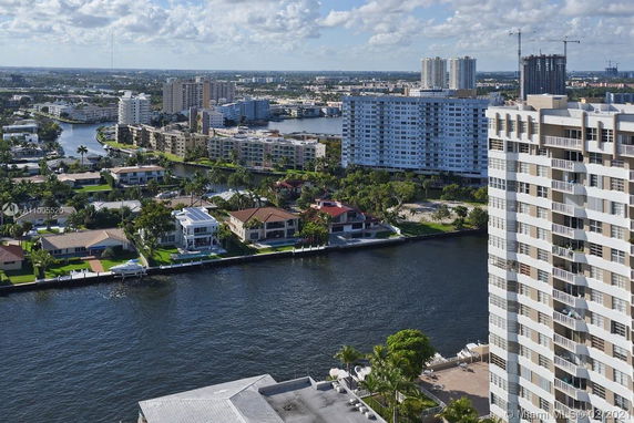 Wide angle view of buildings and waterfront properties in a cityscape.