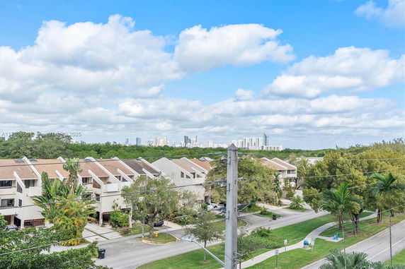 View of residential buildings with a city skyline in the background.