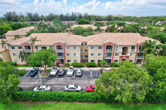 Front view of a multi-story residential building with a tiled roof and balconies.