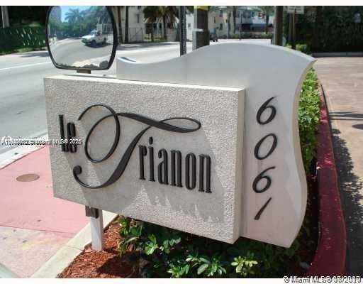 Sign displaying 'Le Trianon' with the number 6061 on a street corner.