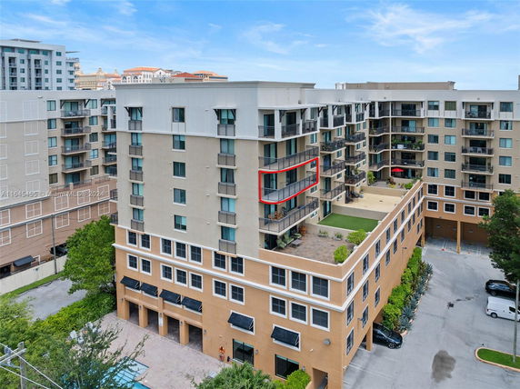 Front view of a multi-story residential building with balconies.